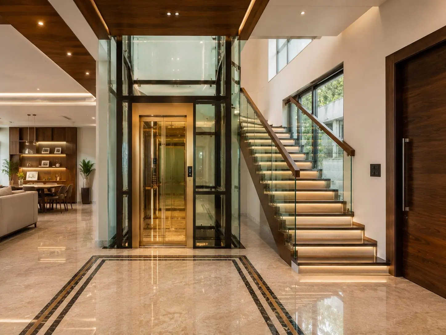 A warm wood panelled lift lobby with a perforated backlit ceiling and marble diamond inlay flooring leading to the closed brushed steel CASTOR car doors.
