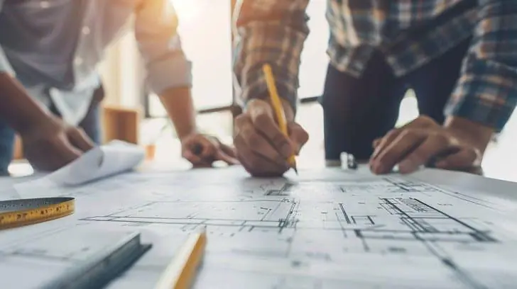 Consultants reviewing building plans and a traffic study